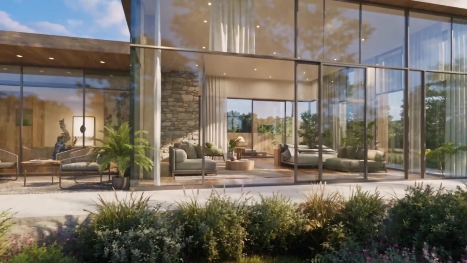 Inside a glass home: a stone hearth, soft sofas and full-height glass open to the garden