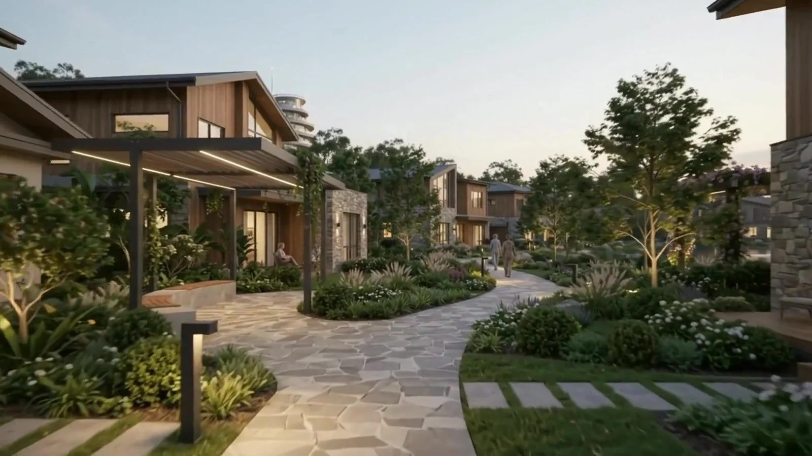 A stone path winding between homes and planted gardens toward the Centre